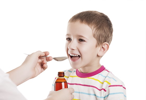 boy taking medicine